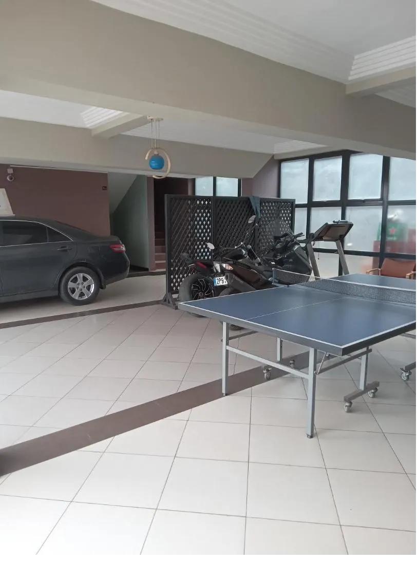 Espace couvert avec table de tennis de table et matériel de fitness